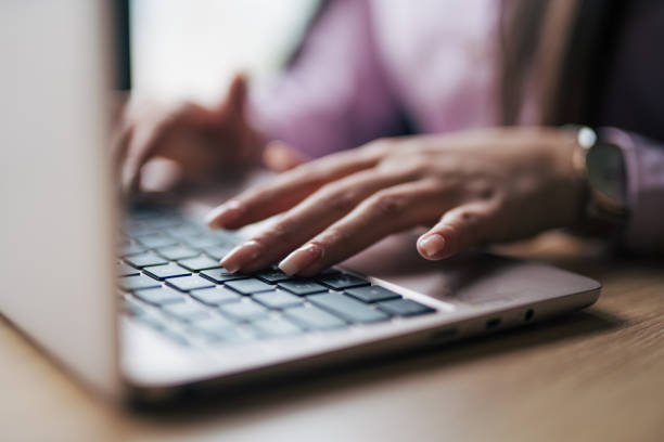 istock Female hands texting on laptop keyboard close up 1930645996