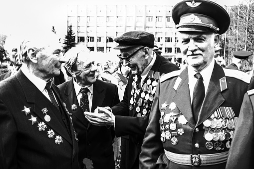 05-09-2005 Krasnogorsk RU. Day of Victory in  the Great Patriotic War (Second World War): Comrades in Arms smiling  in outdoor.\n They have military orders and medals (Russian and Americans fought together in war 80 ago)