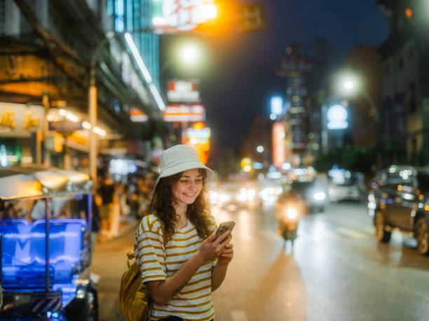istock Woman using smartphone while exploring Chinatown in Bangkok during vacation 1930722519
