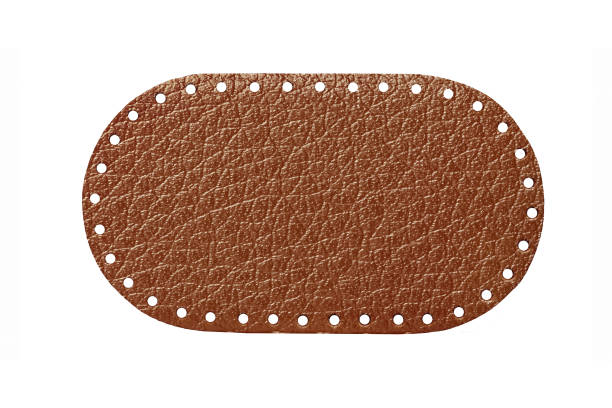 istock Brown leather belt strap closeup isolated on white. Brown stitched leather seam frame label tag isolated on white. 1930736074