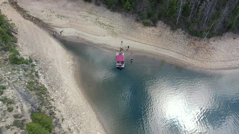 Aerial view of family and friends enjoying afternoon boating on Lake Granby in Arapaho National Recreation Area, Colorado on sunny summer day.