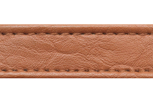 istock Brown leather belt strap. Closeup isolated on white. Cutout object fashion. Thread seam line. 1930751791