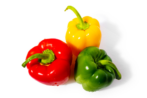 Three bell peppers, red pepper , green pepper and yellow pepper on the white background. Colorful paprika. Product photography.