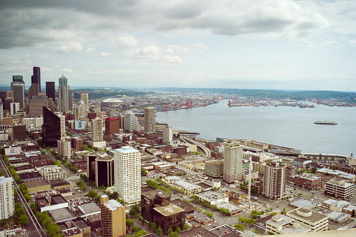 Grainy film photograph of downtown Seattle buildings and Puget Sound waterfront in Washington State.  Shot May 1992.