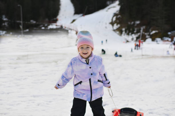 istock A girl with snow bob sledding in the snow 1930786756