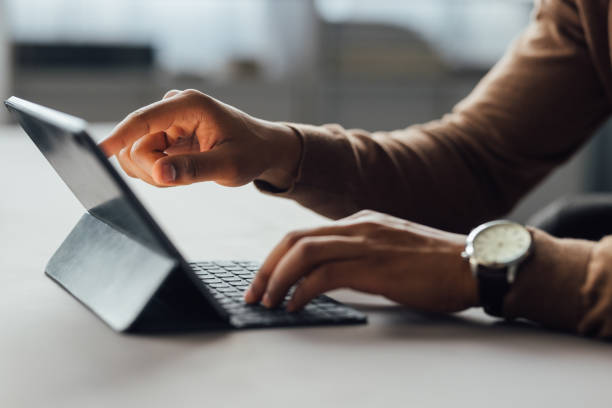 istock Hands of an Anonymous Businessman Using Tablet in Office 1930805050
