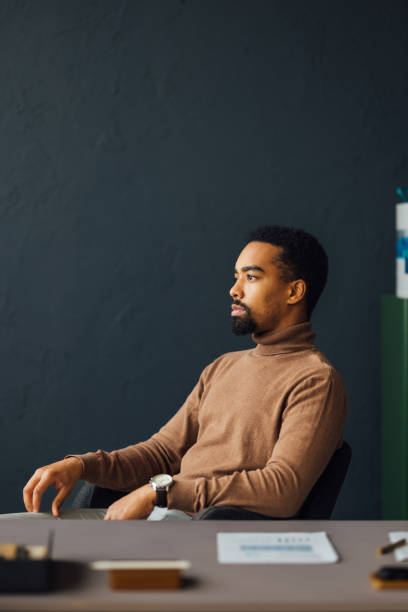 istock Office Worker Seated at Desk in Thought 1930805071
