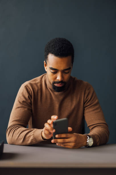 istock Online Business: Businessman on Mobile Phone at Desk 1930805075