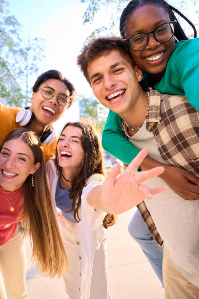 istock A large multiracial group of teenagers taking a selfie looking front camera laughing 1930839328