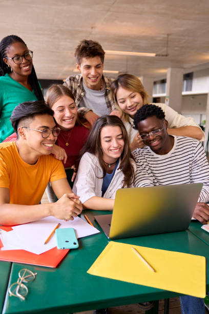 istock A large group of young multiracial students gathered in classroom smiling and having fun watching 1930867381