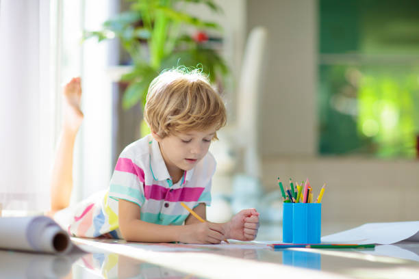 istock Child drawing. Kid painting rainbow. 1930888035