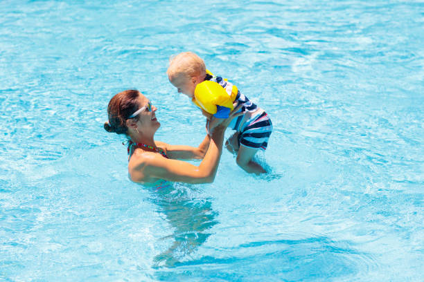 istock Mother and baby in swimming pool 1930888544
