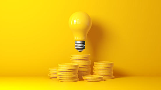 Rising Energy Cost Concept. Light bulb on Top of a Stack of Yellow Gold Coins on Yellow Studio Background. Concept of Creative Idea and Innovation, Unique. 3D Render.