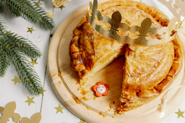 istock One cut royal galette with a crown and a surprise gift on the table. 1930909608