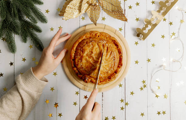 istock Woman's hands cut a royal galette into pieces on the table. 1930909610