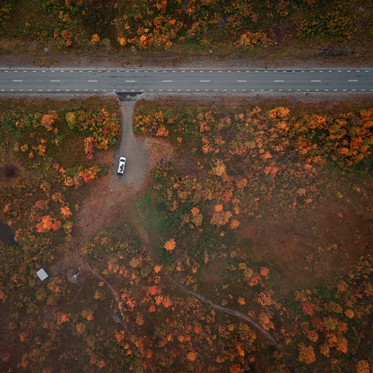 Wild camping with VW Bulli campervan in the countryside of Lapland at Stokenjokk Plateau in autumn in Sweden, from above