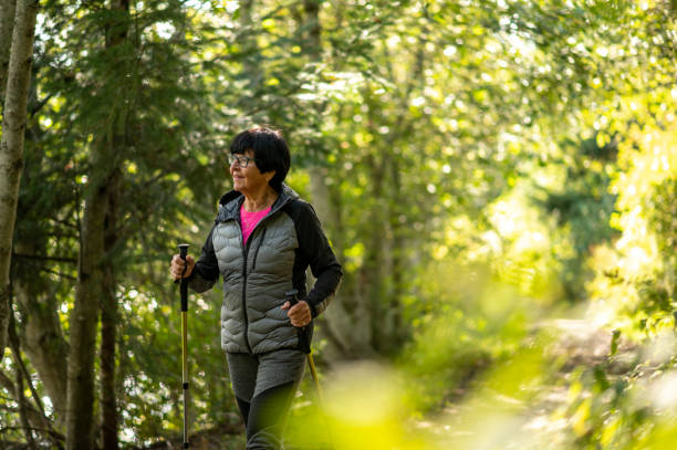 istock Senior woman hikes through forest 1930961398