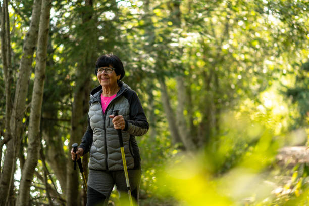 istock Senior woman hikes through forest 1930962992