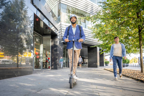 istock Well-dressed man riding electric scooter 1930967909