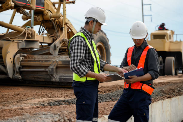 istock Highway engineers discuss plans for construction improvement based on roadworks. Soil Fill, Backfill Compaction for Sub base, Base Course, Surveyor Engineer inspector in highway construction. 1930970076