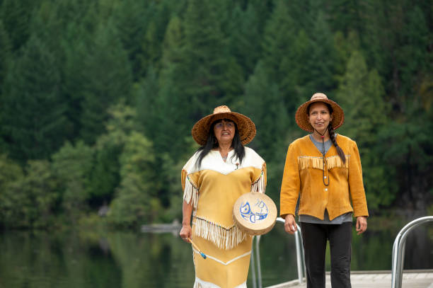 istock Indigenous women stand on lake pier together 1930980855
