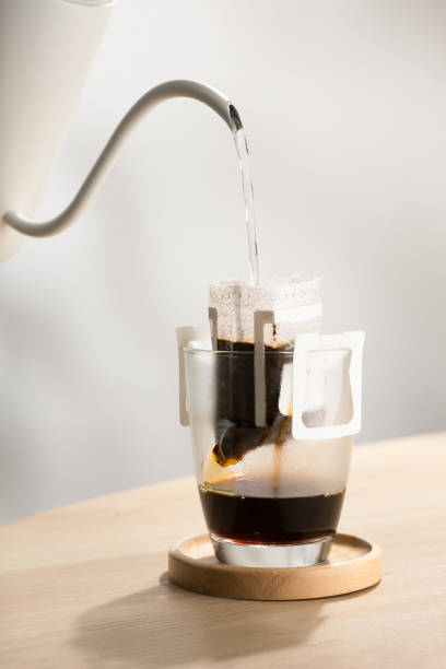 Brewing coffee through pre-made paper filters.