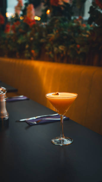 citrus bliss: orange alcoholic cocktail with white foam and zest on restaurant table - crushed ice colors grape fruit стоковые фото и изображения