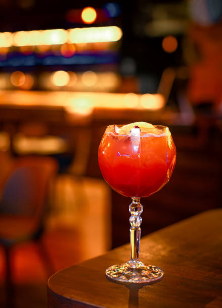 citrus bliss: orange alcoholic cocktail with white foam and zest on restaurant table - crushed ice colors grape fruit ストックフォトと画像