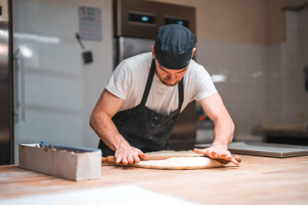 istock Caucasian Working On A Dough In An Artisan Bakery 1930987971