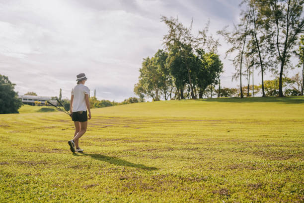 istock Asian Chinese female golfer walking on golf course weekend morning 1930990048