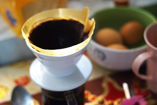 coffee filter on a coffee cup, coffee preparation in the kitchen, morning breakfast