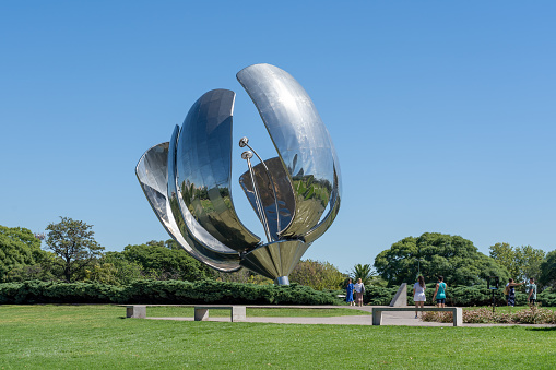 People visting Big Steel Flower (Floralis Generica) in Buenos Aires, Argentina - January 23, 2023. Big Steel Flower is one of the most significant icons of Buenos Aires.