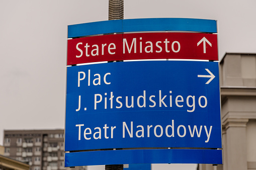 Hollow red circle sign with exceptions written below in Spanish and Basque, photographed in Bilbao, Spain, in summer