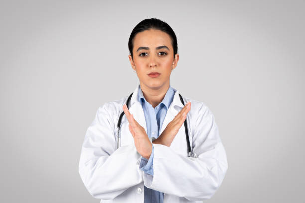 istock Serious woman doctor confidently showing no gesture over grey background 1931079169