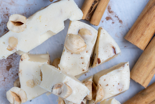 homemade white chocolate with cinnamon and nuts, soft delicious and sweet white chocolate and hazelnuts