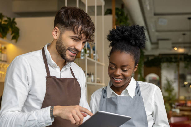 istock Pizzeria worker standing together and discussing something 1931089642