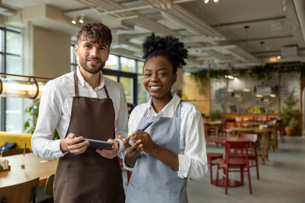 istock Pizzeria worker standing together and discussing something 1931089692