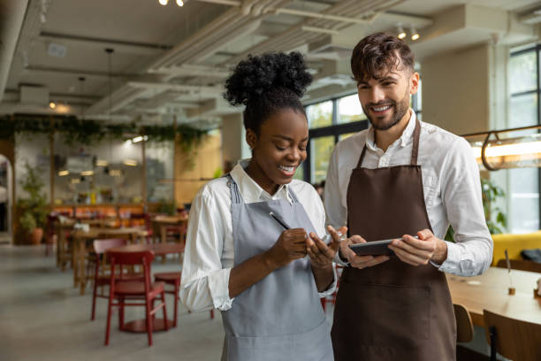 istock Pizzeria worker standing together and discussing something 1931089700