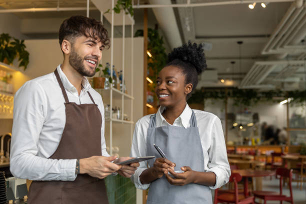istock Pizzeria worker standing together and discussing something 1931089701