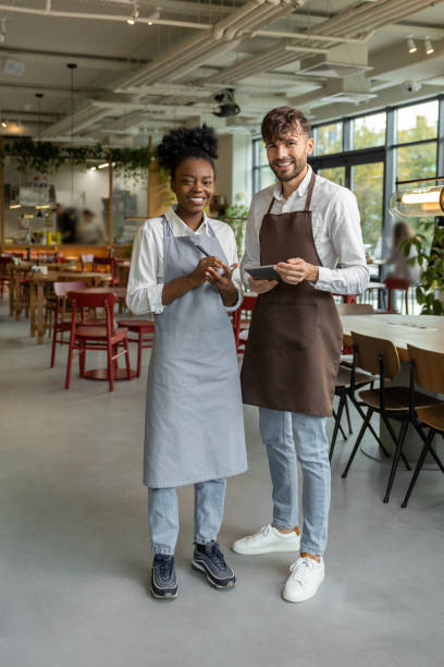 istock Pizzeria worker standing together and discussing something 1931089716