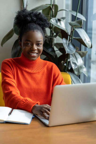 istock Pretty young female working on laptop and smiling 1931091957