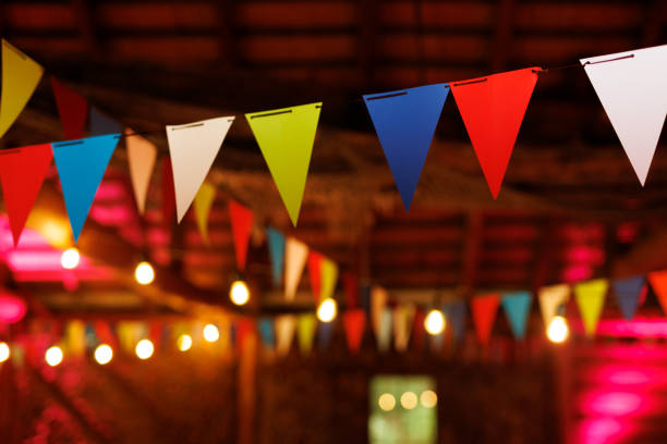istock Festive party venue decorated with colorful pennant banners and string lights 1931095851