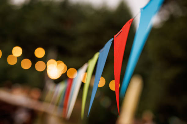 Festive party venue decorated with colorful pennant banners and string lights.