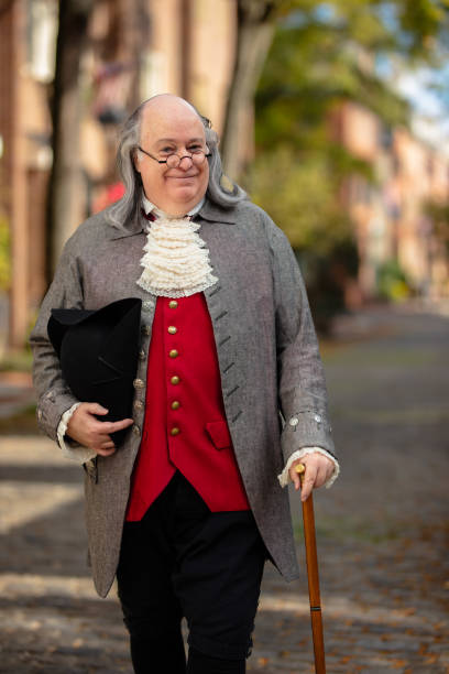 medium wide shot of benjamin franklin impersonator standing with hat and cane - benjamin franklin history american culture portrait imagens e fotografias de stock