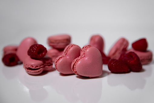 Pink heart-shaped macaroons on a white background. Valentine Day.