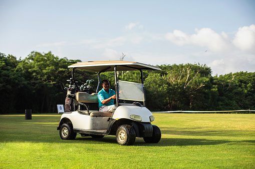 Golfer driving golf cart