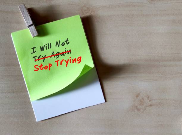 istock Note on copy space grey wall with handwritten text I WILL NOT TRY AGAIN, change to I WILL NOT STOP TRYING, to overcome negative self talk and replace with positive one, self motivation to not give up 1931130765