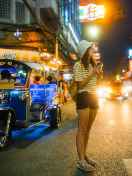 istock Woman using smartphone while exploring Chinatown in Bangkok during vacation 1931140454