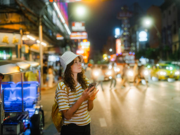 istock Woman using smartphone while exploring Chinatown in Bangkok during vacation 1931190453