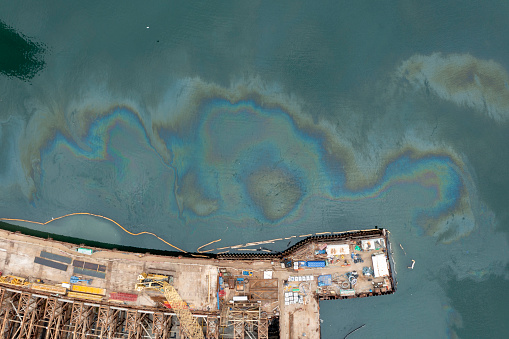 2024 Jan 14,Hong Kong.\nAerial view of Construction site at the seaside with polluted oil on the water.